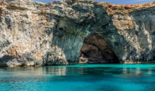 a cave in the side of a rocky cliff at Villa Naxxar Malta in Naxxar