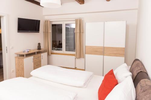 a living room with a white couch and a tv at Scheinerhaus in Laa an der Thaya