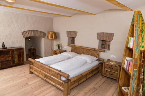 a bedroom with a large wooden bed in a room at Scheinerhaus in Laa an der Thaya