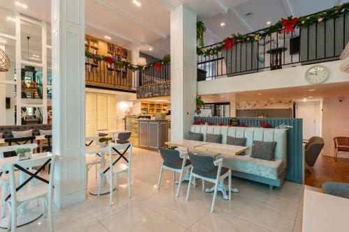 a restaurant with tables and chairs and a staircase at White Ivory Bed And Breakfast in Bangkok