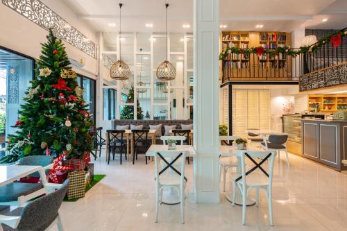 a christmas tree in the dining room of a restaurant at White Ivory Bed And Breakfast in Bangkok