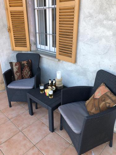 a patio with two chairs and a table with candles at I 5 Sensi Country in Brusnengo