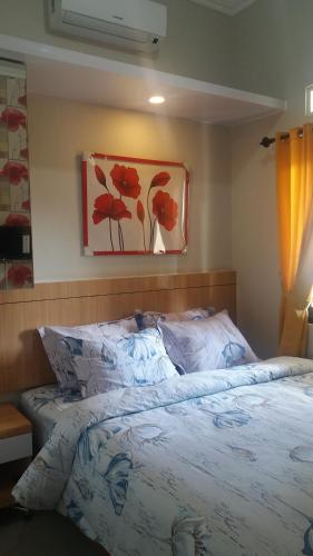 Ένα ή περισσότερα κρεβάτια σε δωμάτιο στο Asaby Homestay Yogya