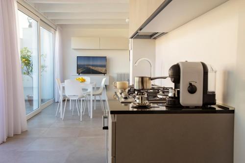 a kitchen with a coffee maker on a counter at Le Cupole Suites & Apartments in Trapani