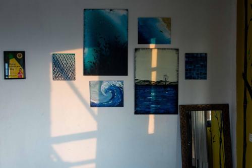 a group of pictures on a wall at Wander Thirst in Kathmandu