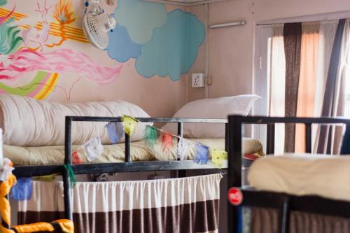 a room with two bunk beds and a wall with clouds at Wander Thirst in Kathmandu