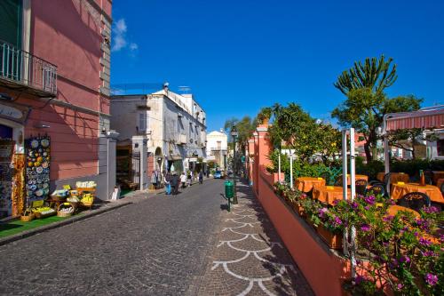 a street in a town with buildings and flowers at Boutique House Fiò in Ischia