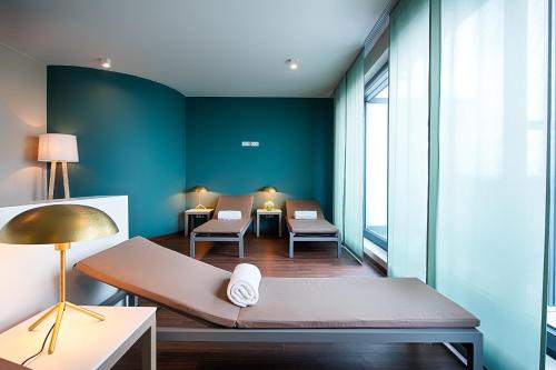 a waiting room with a couch and chairs in a building at Welcome Hotel Neckarsulm in Neckarsulm
