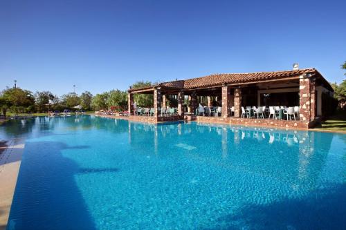 a large pool of blue water in front of a building at Valeria Dar Atlas All Inclusive in Marrakech