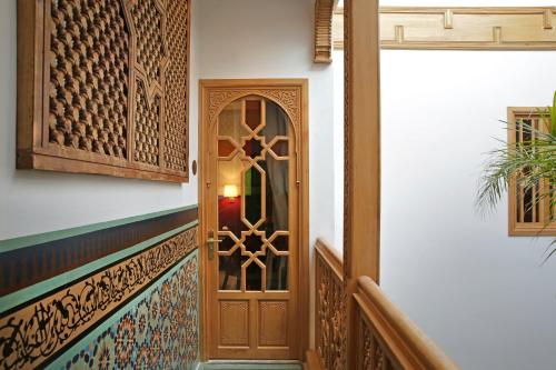 a wooden door with a glass window on a stairway at La Maison Arabe Hotel, Spa & Cooking Workshops in Marrakesh