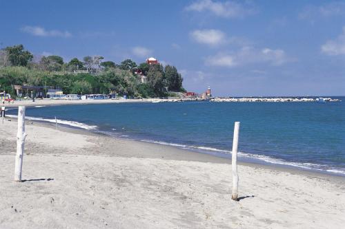 a beach with two volleyball posts in the sand at Boutique House Fiò in Ischia