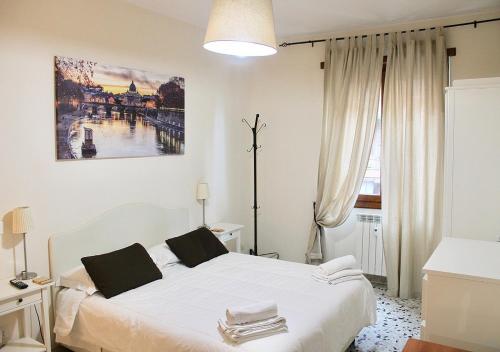ein Schlafzimmer mit einem weißen Bett und einem großen Fenster in der Unterkunft Amazing Vaticano in Rom