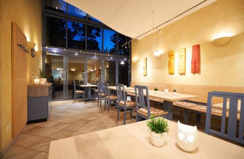 a restaurant with a long table and chairs at Landgasthof Zehner in Drosendorf