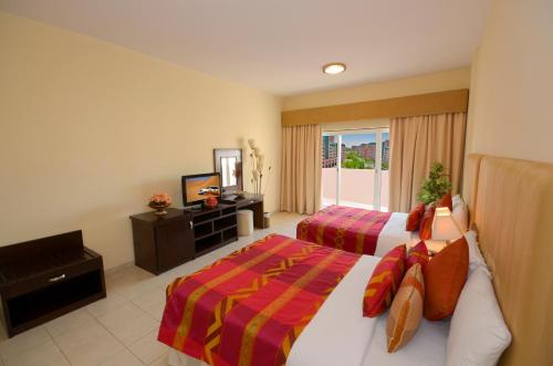 Ένα ή περισσότερα κρεβάτια σε δωμάτιο στο Parkside Hotel Apartment