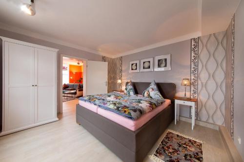 a bedroom with a large bed and a living room at Haus Mozart in Binz