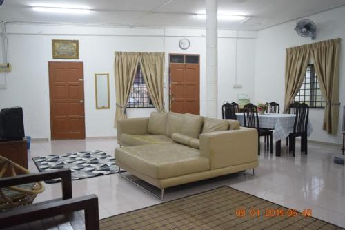 a living room with a couch and a table at RILEK-RILEK HOMESTAY in Jertih