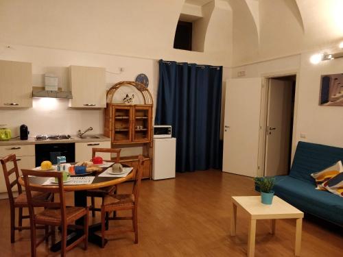 a living room with a table and a blue couch at Due di Coppa in Scafati