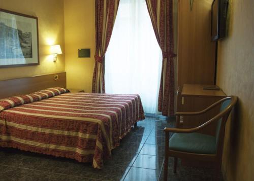 a hotel room with a bed and a window at Hotel Agorà in Rome