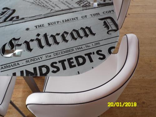 a white chair with a sign on the back of it at Habitaciones Mar Azul in El Quisco