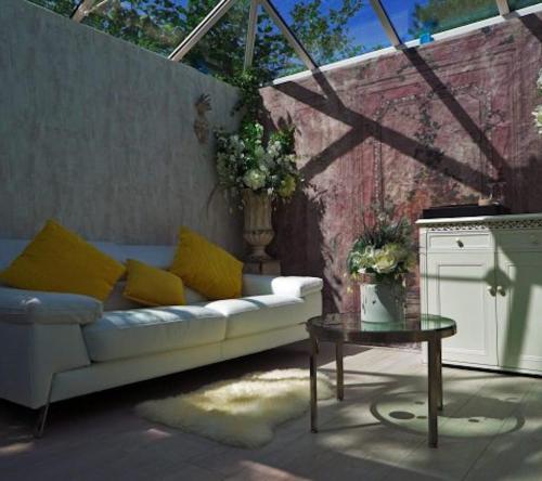 a living room with a couch and a table at Who'd A Thought It in Lenham