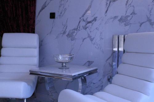 a table with a trophy on it next to two chairs at Who'd A Thought It in Lenham
