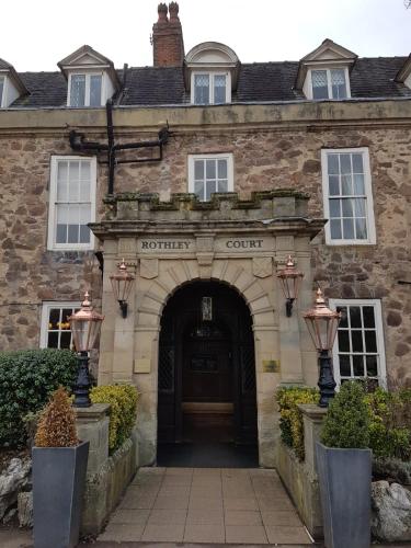 an entrance to a stone building with a door at Rothley Court Hotel by Greene King Inns in Rothley