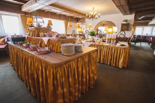 a dining room with a table with yellow table cloth at Hotel Donnerhof in Fulpmes