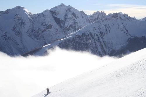 a person is skiing down a snow covered mountain at Hotel Donnerhof in Fulpmes
