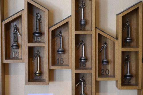 a row of wooden doors with numbers on a wall at The Originals City, Hôtel Le Cheval Rouge, Tours Ouest in Villandry