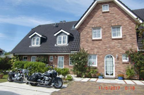deux motos garées devant une maison en briques dans l'établissement Mittelreihenhaus Carla - Sylt, Westerland, à Tinnum