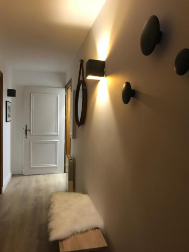 a room with a door and a bench and a light at La Résidence de L'Ours in Megève