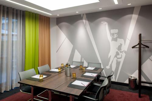 a conference room with a table and chairs at Mercure München City Center in Munich