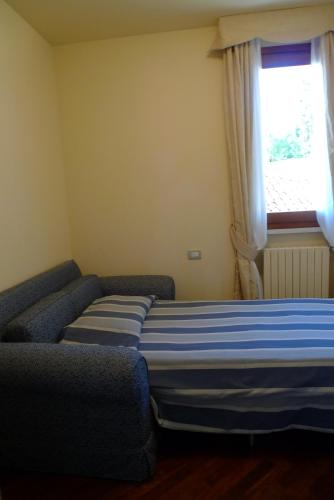 Cama o camas de una habitación en Appartamenti Borgo