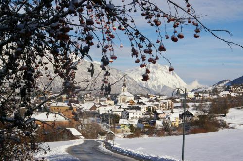 a town in the snow with a mountain in the background at Thalerhof in Roppen