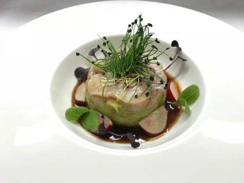 a white bowl of food with meat and vegetables at City-Hotel Ochsen in Zug