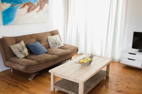 a living room with a couch and a coffee table at Sedgefield Beach House/Sedgefield Strandhaus in Sedgefield