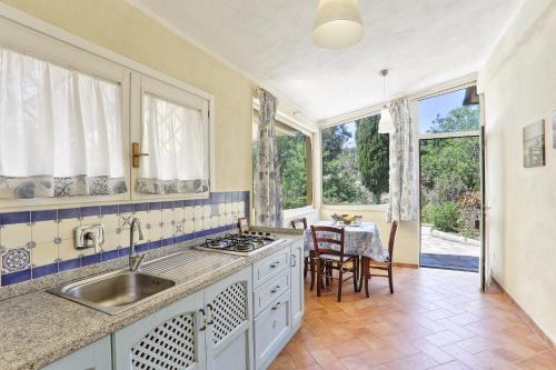 a kitchen with a sink and a table at Rosa dei Venti Est in Capoliveri