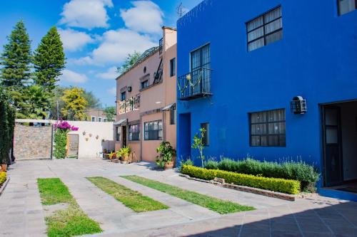 a blue apartment building with a courtyard at Hotel Casa Santamaría in San Miguel de Allende
