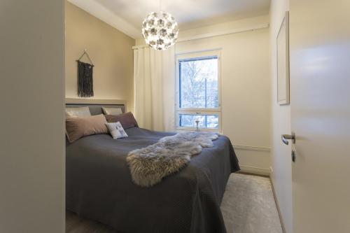 a bedroom with a bed and a window at Tuomas´ luxurious suites, Livo in Rovaniemi