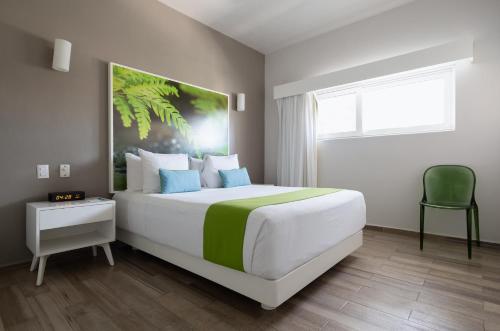a bedroom with a large white bed and a window at Azura Boutique Hotel in Tulum