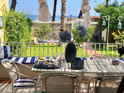 a white table with a plate of food on it at VILLA DEL MELOGRANO in Patti