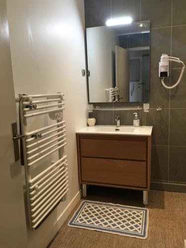 a bathroom with a sink and a mirror at Le Turenne in Bordeaux