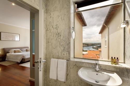 a bathroom with a sink and a window at Casas Da Formiga - Riverview Terrace and Pool in Porto
