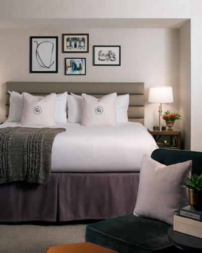 a large bed with white pillows in a hotel room at Claridge House in Chicago