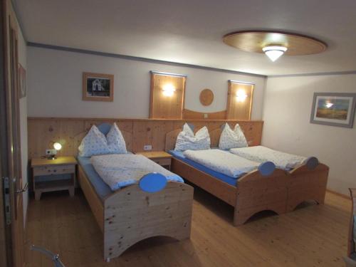 1 dormitorio con 2 camas individuales y almohadas azules en Arkadenhof Fam. Schneider, en Eichenbrunn