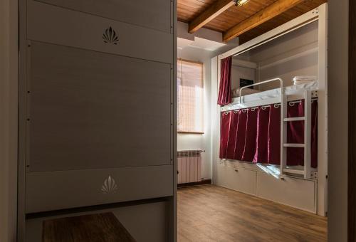 a room with a closet with a large door at Bercianos1900 in Bercianos del Real Camino