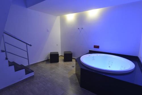 a bathroom with a large tub in a room at Eros Hotel CDU (Adults Only) in Recife