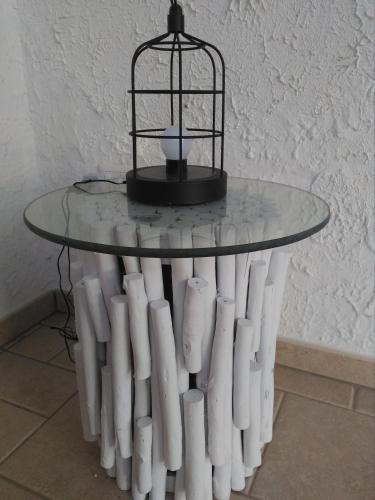 a table with a bird cage on top of it at Villetta Dote in Casarano