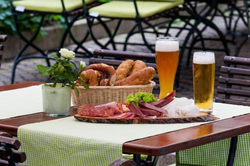 a table with a basket of food and a glass of beer at Mercure München City Center in Munich
