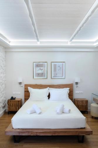 a bedroom with a bed with two towels on it at Karalis Beach in Pylos